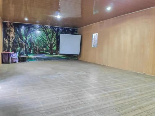 a large room with a projection screen in a room at Chikar Glamping At Wisata Coban Talun Mitra RedDoorz in Junggo