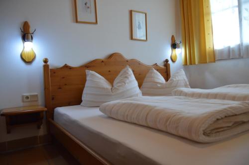 a bedroom with two beds with white pillows at Panorama Apartment Gerlitzen in Treffen