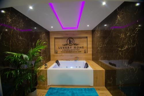 a bathroom with a bath tub with a purple lighting at LUZ DE PATIOS in Huelva