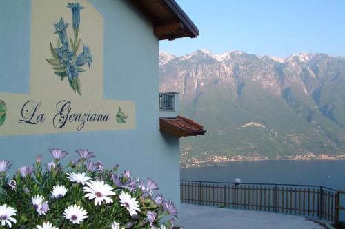 a sign on the side of a building with flowers at Hotel Panorama e Residence in Tremosine Sul Garda