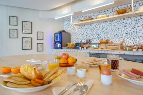 a table with plates of food and fruit on it at greet hotel Salon de Provence in Salon-de-Provence