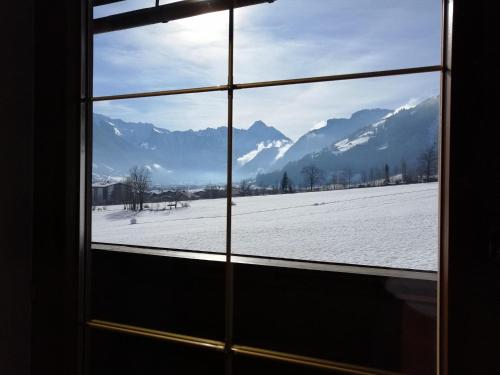 a window with a view of a snow covered field at Haus Franka in Zellberg