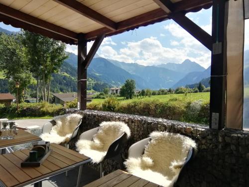 a table and chairs with a view of mountains at Haus Franka in Zellberg