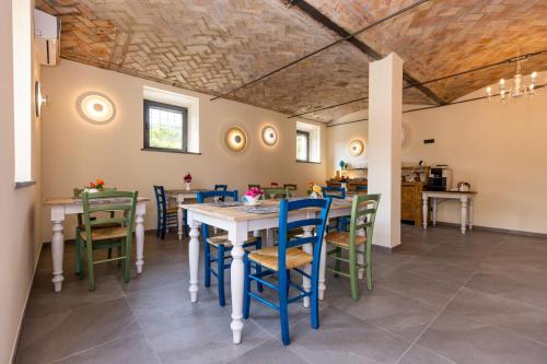 a dining room with a table and chairs at Agriturismo I Tre Colli in Viazzano