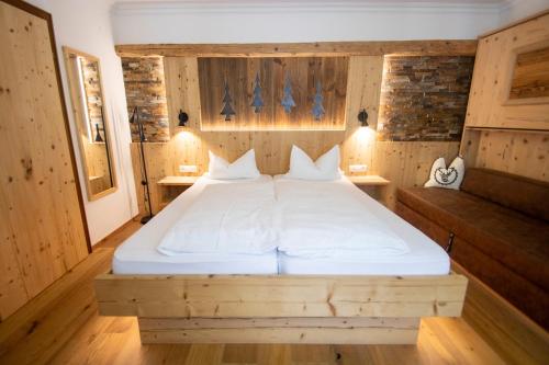 a bedroom with a bed in a wooden room at Aktivhotel Waldhof in Oetz