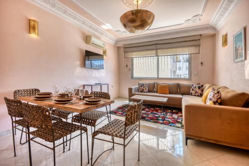 a living room with a table and chairs and a couch at FAR - Down Town - 5 PX in Agadir