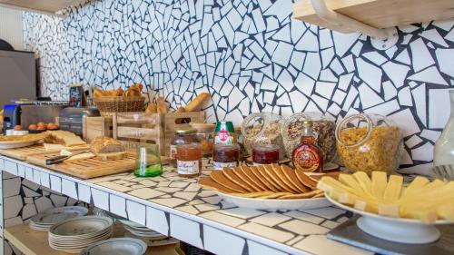 a buffet with bread and other food on a counter at greet hotel Salon de Provence in Salon-de-Provence