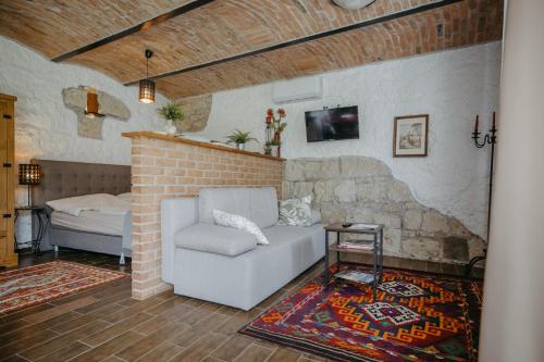 a living room with a couch and a bed at Haus Diogenes in Mörbisch am See