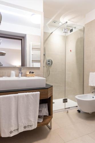 a bathroom with a sink and a shower at Olimpia Hotel in Bormio