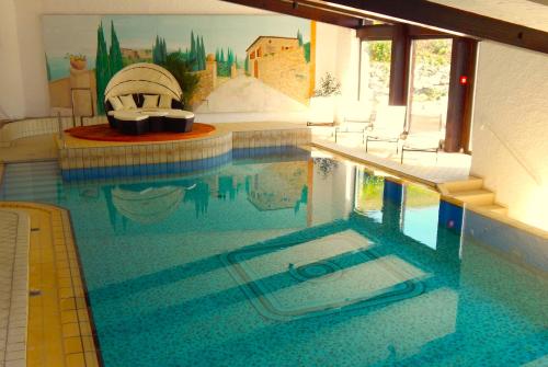 a model of a swimming pool in a house at Vital Lodge Allgäu mit Oberstaufen PLUS in Oberstaufen
