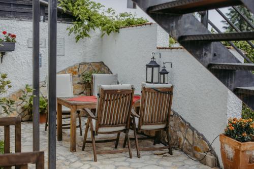 a patio with a table and two chairs and a lamp at Haus Diogenes in Mörbisch am See