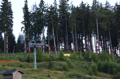 a park with a bunch of ski equipment in a forest at Panorama Apartment Gerlitzen in Treffen