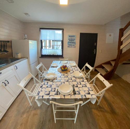 a kitchen with a table and chairs in a kitchen at A Morze Ustka in Ustka