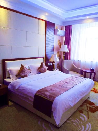 a bedroom with a large bed and a window at Golden Peacock Hotel Blantyre in Blantyre