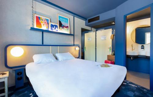 a bedroom with a large white bed in a room at greet hotel Salon de Provence in Salon-de-Provence