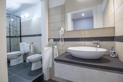 a bathroom with a tub and a sink and a toilet at Royal Playa Suite and Apartament -private parking- self chek out in Catania