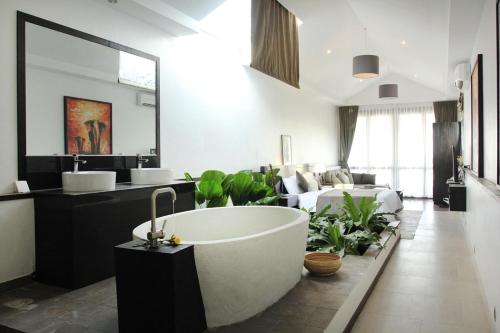 a bathroom with a bath tub and a living room at Blue Crystal boutique Hotel in Phnom Penh