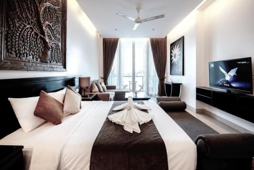 a large bedroom with a large bed with a tv at Blue Crystal boutique Hotel in Phnom Penh