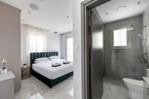 a bedroom with a bed and a bathroom with a shower at Villa Green Haven 2 Protaras Cyprus in Protaras