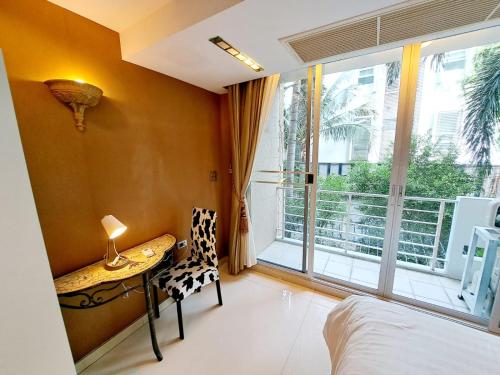a bedroom with a bed and a table and a window at 2D-Cozy 35bedrooms35bathrooms Bkk Downtown in Makkasan