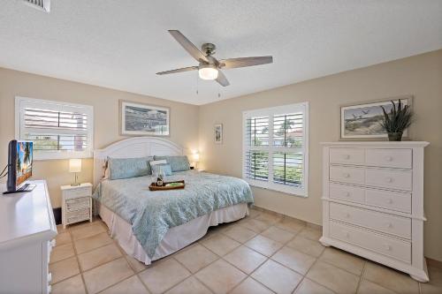 a bedroom with a bed and a ceiling fan at 310 West Flamingo Circle in Marco Island