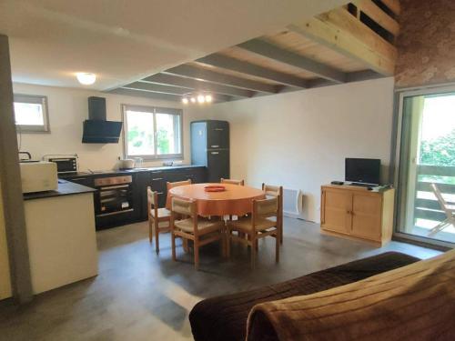 une cuisine et une salle à manger avec une table et des chaises dans l'établissement Appartement Duplex Calme 6 pers, Terrasse, Parking Privé, 500m du Centre - FR-1-234-252, à Cauterets