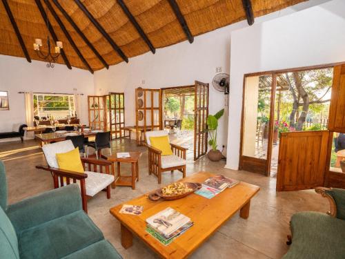a living room with a table and chairs at Drift Inn in Victoria Falls