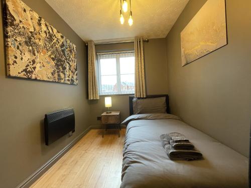 a bedroom with a bed and a television and a window at No24 - 2-bed Boutique Apartment - Hosted by Hutch Lifestyle in Leamington Spa