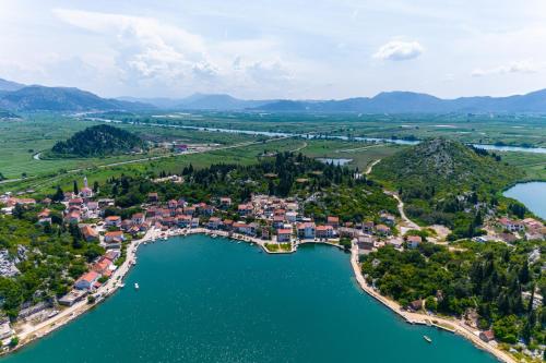 an aerial view of a small town on a lake at Apartments Ema in Rogotin