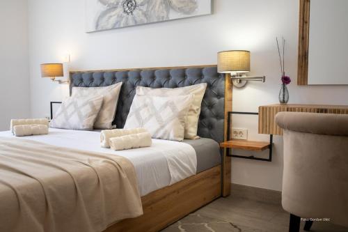 a bedroom with a large bed with a blue headboard at Secret Escape in Rovinj