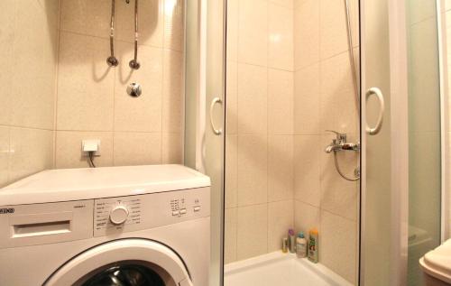 uma casa de banho com uma máquina de lavar roupa e um chuveiro. em 1bd Modern Apt in Dobra Voda with Roof Access "Moka" em Bar