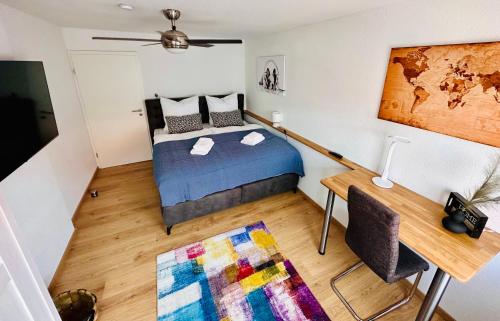 a bedroom with a bed and a desk and a table at FeWo Bachlauf mit großer Terrasse in Bad Harzburg