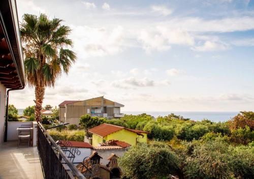 a balcony with a view of a house and the ocean at Residenza Anna Calabria in Briatico