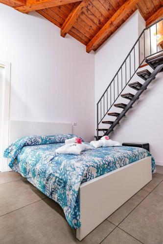 a bedroom with a bed and a staircase at Residenza Anna Calabria in Briatico