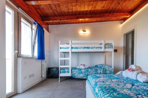 a bedroom with two bunk beds and a window at Residenza Anna Calabria in Briatico