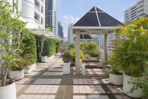 a patio with a gazebo and potted plants at PARKROYAL Suites Bangkok in Bangkok