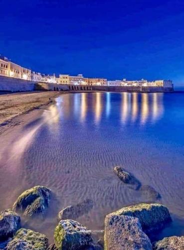 a beach at night with rocks in the water at Villa Zaira in Baia Verde