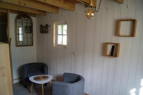 a room with two chairs and a table and a window at Le Domaine de la Claire Fontaine Gîtes -chambres d'hôtes in Montvalent