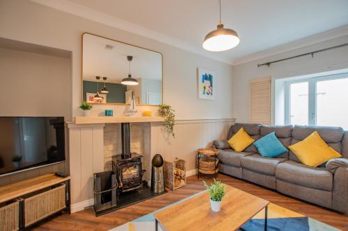 a living room with a couch and a fireplace at Cosy Retreat in The City Centre in Galway