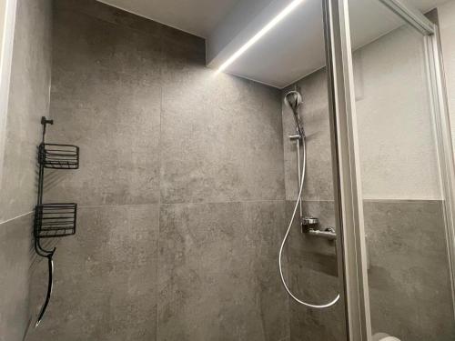 a shower with a glass door in a bathroom at Obinghof in Fieberbrunn