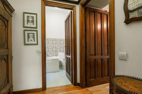 a hallway with a door leading to a bathroom at Casa Panoramica - by My Home In Como in Como