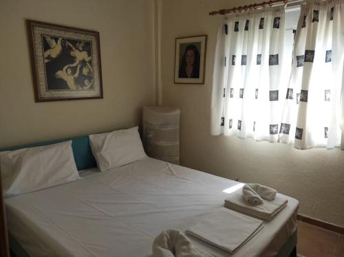 a bedroom with a bed with two towels on it at Summer House 150m from the beach for 5 persons. in Sozopoli