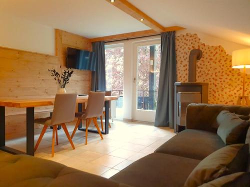 a living room with a table and a couch at Haus Denneberg in Oberstaufen