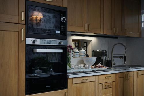 a kitchen with a black oven and a sink at La Maison Bordeaux in Bordeaux