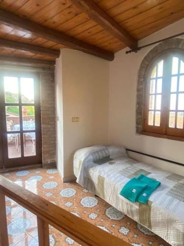 a bedroom with a bed in a room with windows at Superior Stone in Venetico