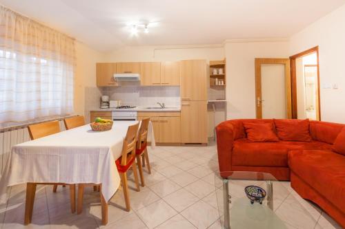 a living room with a table and a couch at Apartment Aldo in Pula