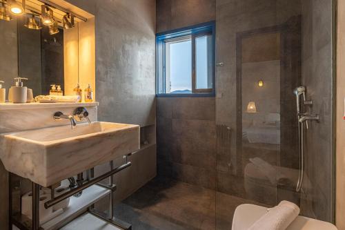a bathroom with a sink and a shower at Hidesign Athens Villa In Sounio in Sounio