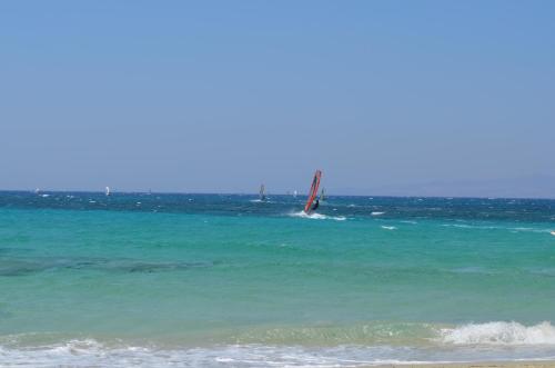 a sail boat in the water on the beach at Aeraki Studios in Kastraki Naxou