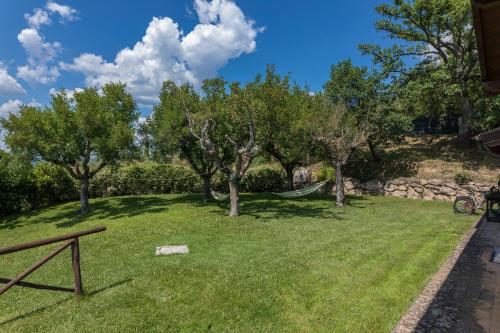 a yard with trees and a playground at IL CASALE DEL NONNO 8&2 Emma Villas in Guardea