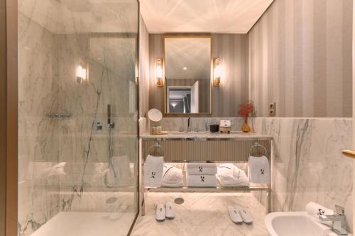 a bathroom with a shower and a sink at GA Palace Hotel & Spa, a XIXth-Century Villa in Porto
